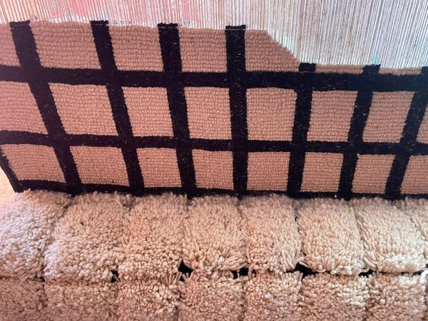 Tapis en cours de tissage sur le métier vertical